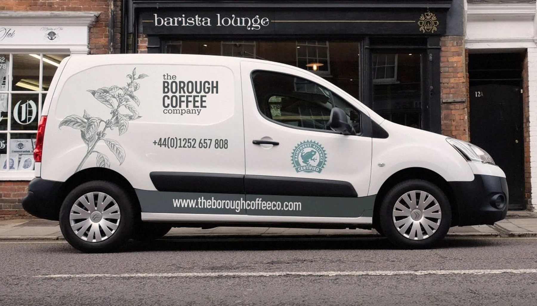 A white delivery van in The Borough Coffee Company livery parked outside a shopfront